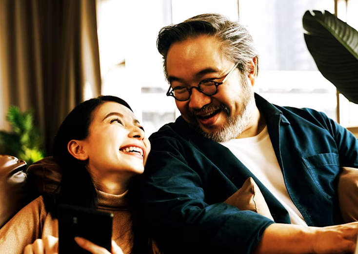 A couple laughing together at home