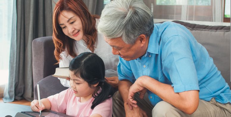 Grandparents helping their granddaughter with homework